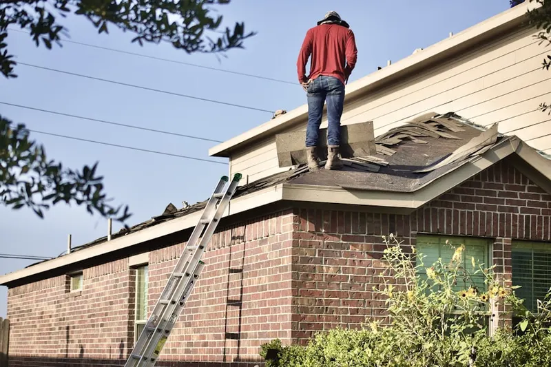 Professional roofer working on a residential roof in Peculiar